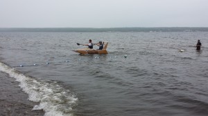 Cardboard Boat Race competitors battle heavy surf.