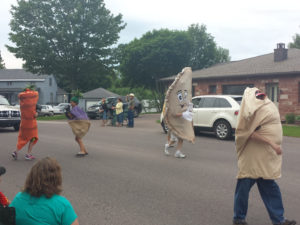 Pasty Fest mascot "Cousin Jack" marches with pasty ingredients in the parade.