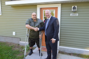 MSHDA Executive Director Kevin Elsenheimer shakes hands with Tom Rossi, the 400th homeowner to purchase a home with help from the Key to Own program.