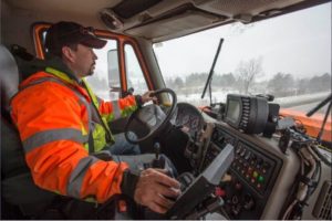 Nate Fisher operates an MDOT tow plow during a winter storm in February 2016. MDOT now has automatic vehicle location (AVL) devices on all of its winter road maintenance equipment. These systems report where each truck is, and they gather data from other sensors in order to help better plan for winter storms. (MDOT Photo)